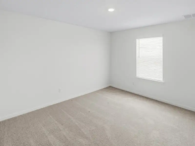 An airy bedroom with fresh carpeting and a well-lit window awaits your personal touch. An airy bedroom with fresh carpeting and a well-lit window awaits your personal touch.