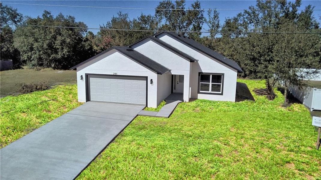 Front exterior of a new home in , Poinciana, FL, highlighting curb appeal (Image 2). Front exterior of a new home in , Poinciana, FL, highlighting curb appeal (Image 2).