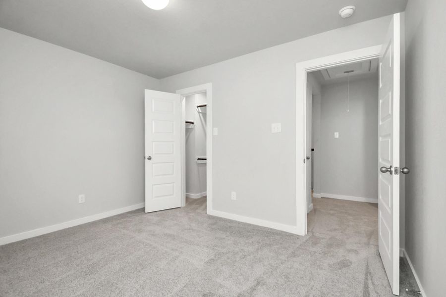 Generously sized secondary bedrooms featuring spacious closets, soft and inviting carpeting underfoot, large windows allowing plenty of natural light, and the added touch of privacy blinds for your personal retreat. Sample photo of completed home with similar floor plan. As-built interior colors and selections may vary. Generously sized secondary bedrooms featuring spacious closets, soft and inviting carpeting underfoot, large windows allowing plenty of natural light, and the added touch of privacy blinds for your personal retreat. Sample photo of completed home with similar floor plan. As-built interior colors and selections may vary.