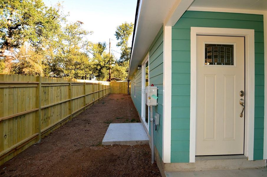 View of side of property featuring a fenced backyard