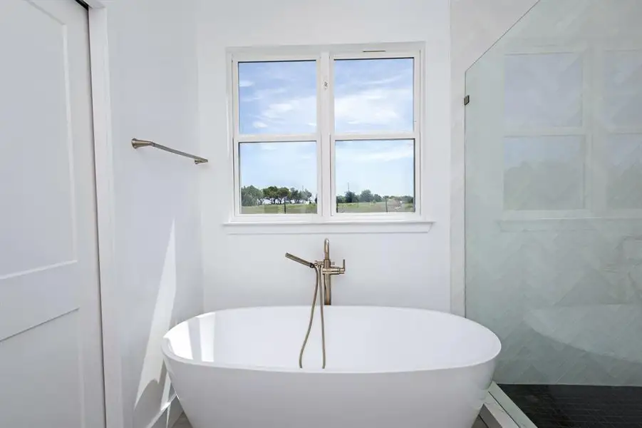 Full bathroom with a soaking tub and a stall shower