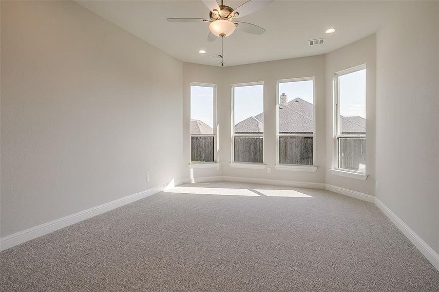 Carpeted empty room with ceiling fan