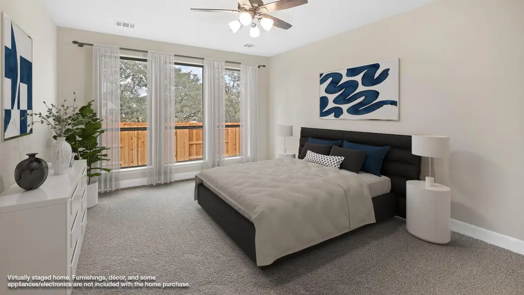 Bedroom featuring light carpet and a ceiling fan