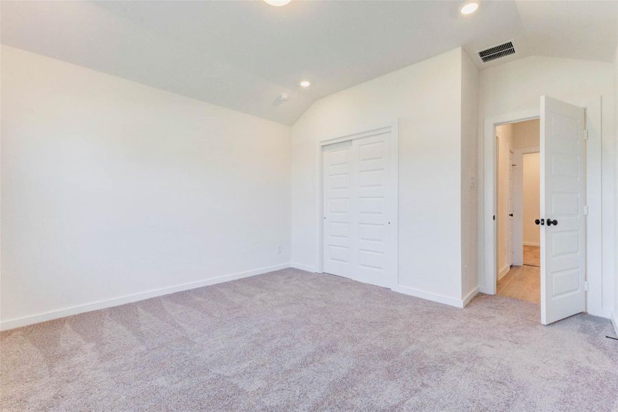 Well-sized secondary bedroom with closet, neutral finishes, and natural light.