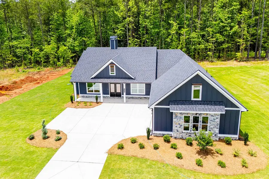 Front exterior of a new home in WOODMONT RESERVE, Roopville, GA, highlighting curb appeal (Image 32).