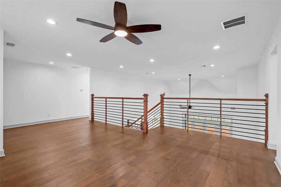 Spare room featuring ceiling fan and wood-type flooring