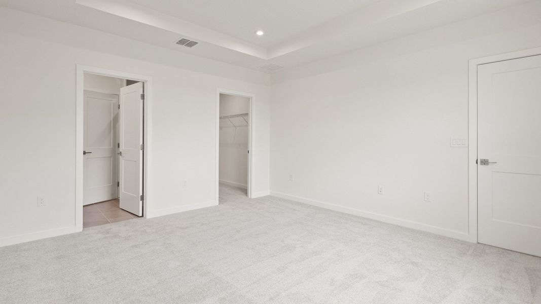 Spacious primary Suite with en suite bath and walk-in closet in the Flagler by DRB Homes in Hamilton Bluff Spacious primary Suite with en suite bath and walk-in closet in the Flagler by DRB Homes in Hamilton Bluff