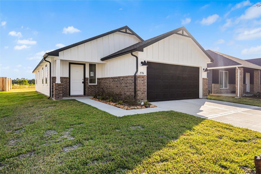 Front exterior of a new home in Hill & Dale Ranch, Splendora, TX, highlighting curb appeal (Image 1). Front exterior of a new home in Hill & Dale Ranch, Splendora, TX, highlighting curb appeal (Image 1).