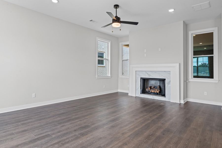 Unfurnished living room with recessed lighting, a fireplace, dark wood finished floors, and a ceiling fan Unfurnished living room with recessed lighting, a fireplace, dark wood finished floors, and a ceiling fan