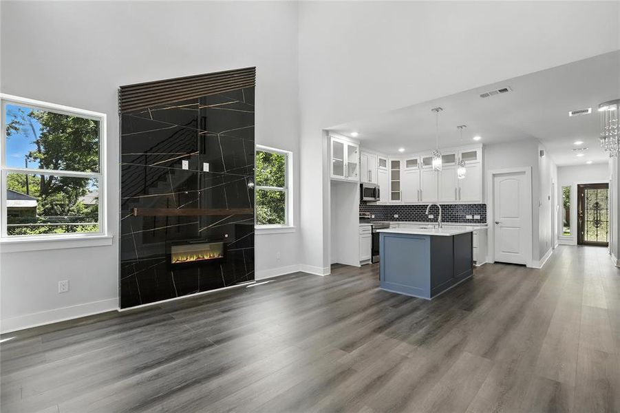 Kitchen featuring white cabinets, light countertops, plenty of natural light, stainless steel appliances, and recessed lighting