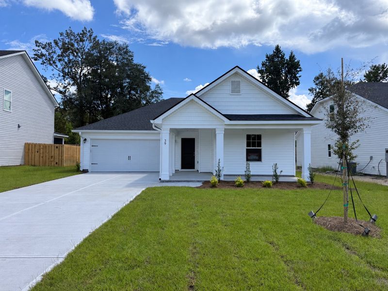 Front exterior of a new home in Sweetwater, Brunswick, GA, highlighting curb appeal (Image 1). Front exterior of a new home in Sweetwater, Brunswick, GA, highlighting curb appeal (Image 1).