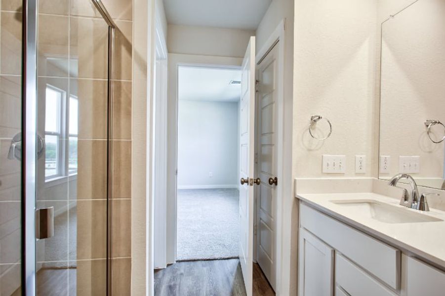 A bathroom with a sink and shower.