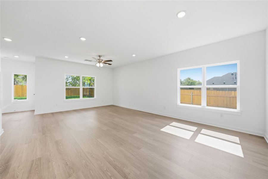 Unfurnished living room with recessed lighting, light wood-style flooring, and a ceiling fan Unfurnished living room with recessed lighting, light wood-style flooring, and a ceiling fan