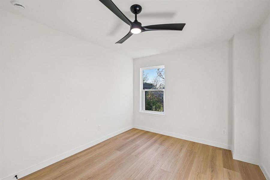 Spare room featuring light wood finished floors and a ceiling fan