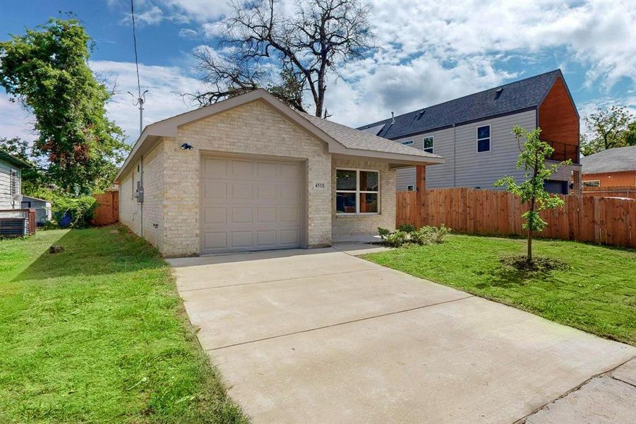 View of front of home featuring a garage and a front yard