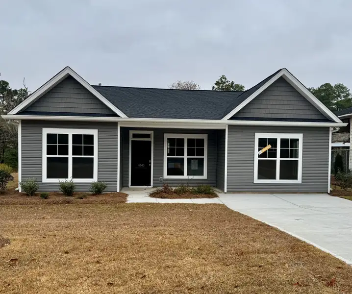 Front exterior of a new home in Satchel Ford, Columbia, SC, highlighting curb appeal (Image 1).