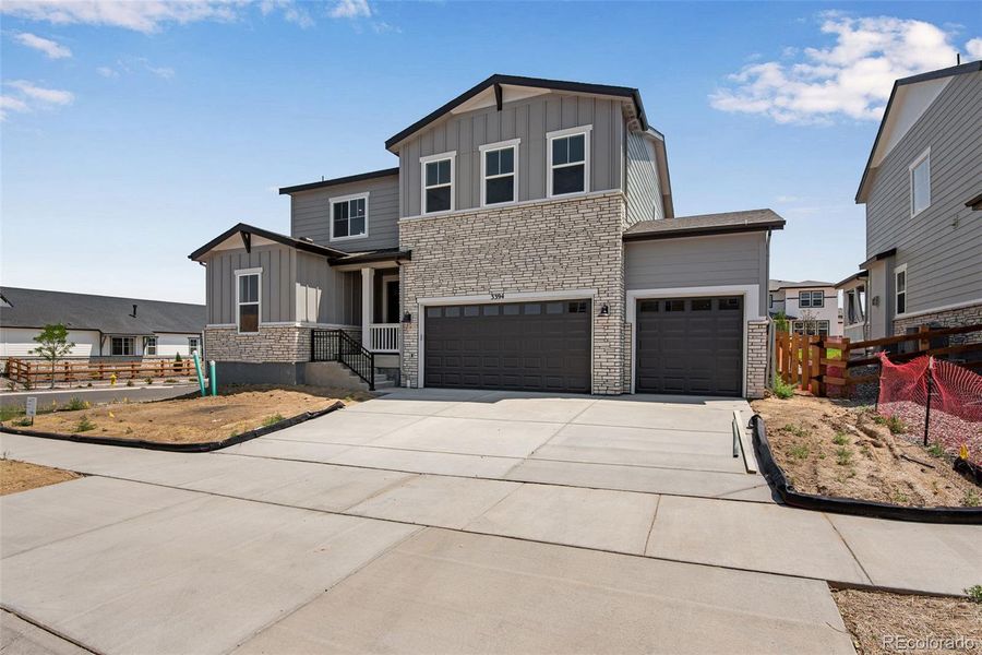 Front exterior of a new home in Ensemble at The Aurora Highlands, Aurora, CO, highlighting curb appeal (Image 25).
