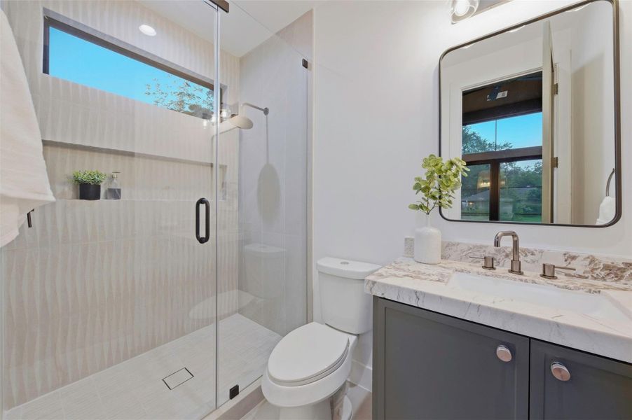 Full bath with walk in shower connected directly to the office.