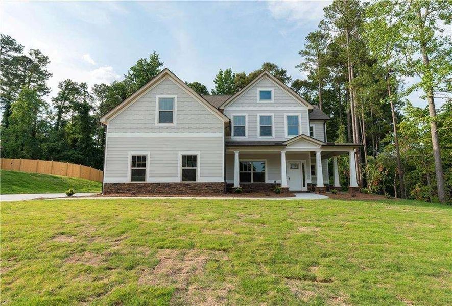 Front exterior of a new home in , Douglasville, GA, highlighting curb appeal (Image 1). Front exterior of a new home in , Douglasville, GA, highlighting curb appeal (Image 1).