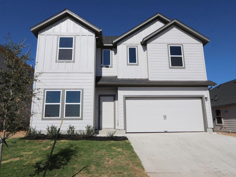 Front exterior of a new home in Cascades at Onion Creek, Austin, TX, highlighting curb appeal (Image 13).