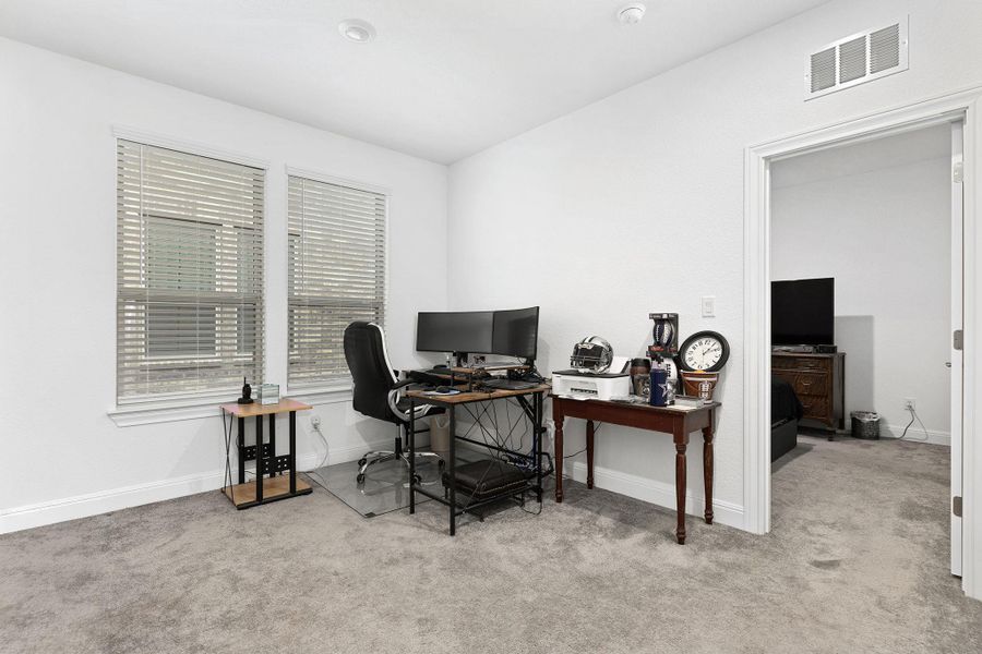 A well-lit bonus room provides a versatile space, perfect for a home office or creative pursuits.