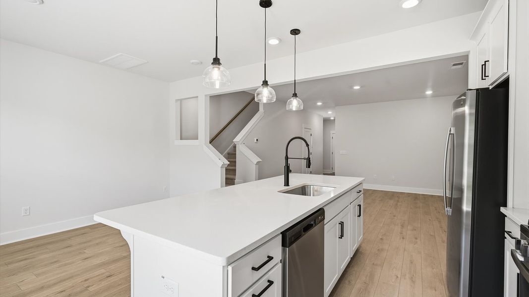 Highly skilled craftsmanship shines in this modern kitchen with pendant lighting and a central island focal point in SC Highly skilled craftsmanship shines in this modern kitchen with pendant lighting and a central island focal point in SC