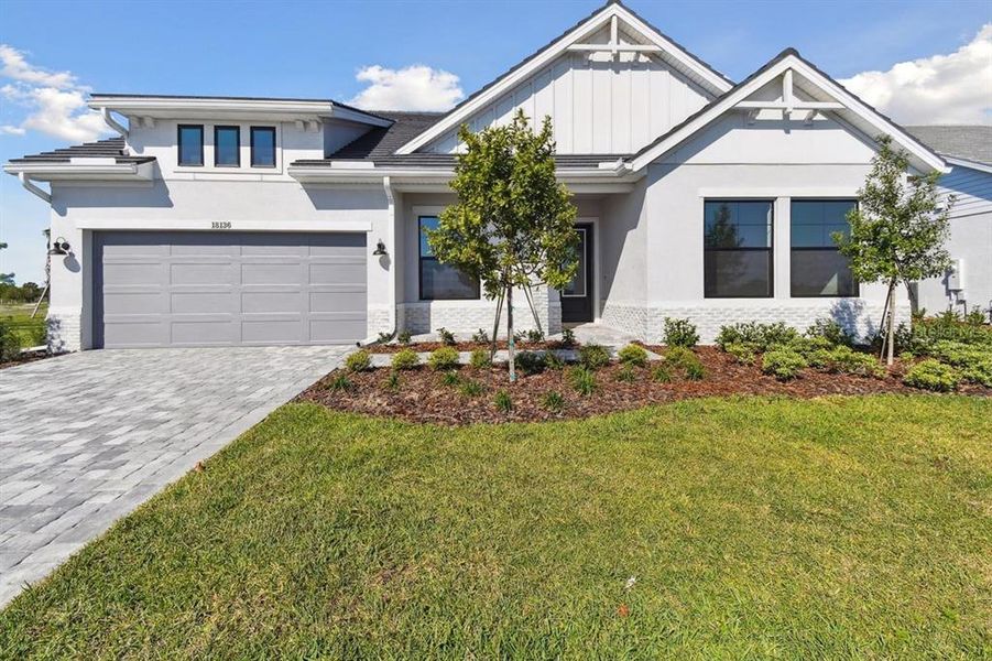 Front exterior of a new home in Palmera Wellen Park - Classic Series, Venice, FL, highlighting curb appeal (Image 4). Front exterior of a new home in Palmera Wellen Park - Classic Series, Venice, FL, highlighting curb appeal (Image 4).
