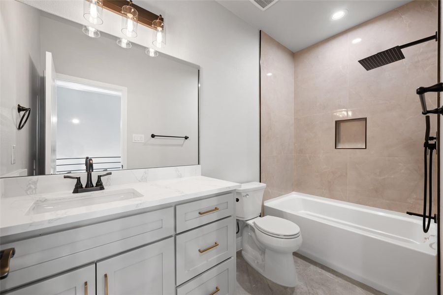 Full bath with bathing tub / shower combination, vanity, and recessed lighting