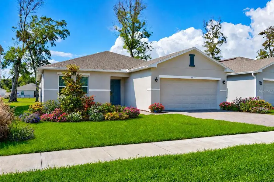 Front exterior of a new home in Riverfront, Edgewater, FL, highlighting curb appeal (Image 2). Front exterior of a new home in Riverfront, Edgewater, FL, highlighting curb appeal (Image 2).