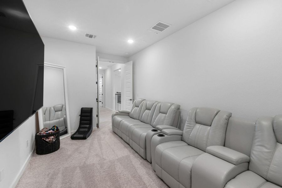 This theatre space is perfect for movie nights, gaming, or relaxing with your favorite shows.