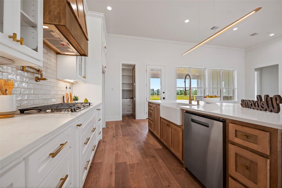 Modern kitchen with sleek cabinetry, elegant countertops, and high-end appliances. Bright and spacious, perfect for culinary enthusiasts.