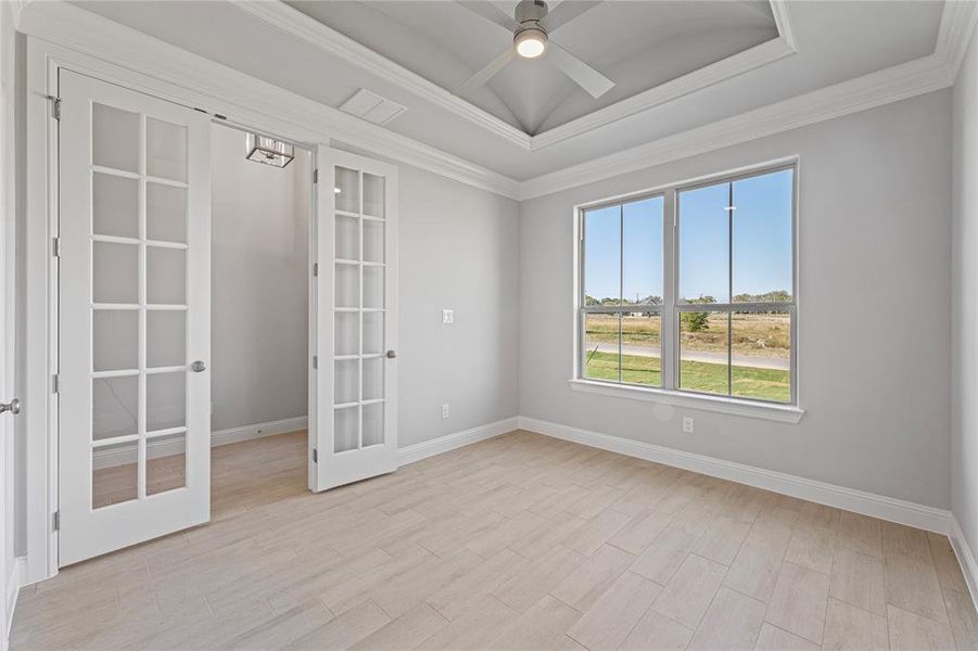 Office featuring french doors, ceiling fan, ornamental molding, and light wood-type flooring