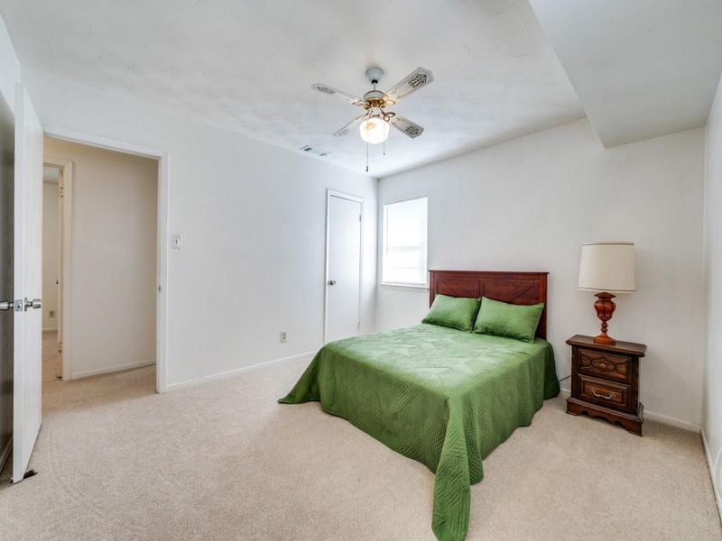 Bedroom with light colored carpet and a ceiling fan Bedroom with light colored carpet and a ceiling fan