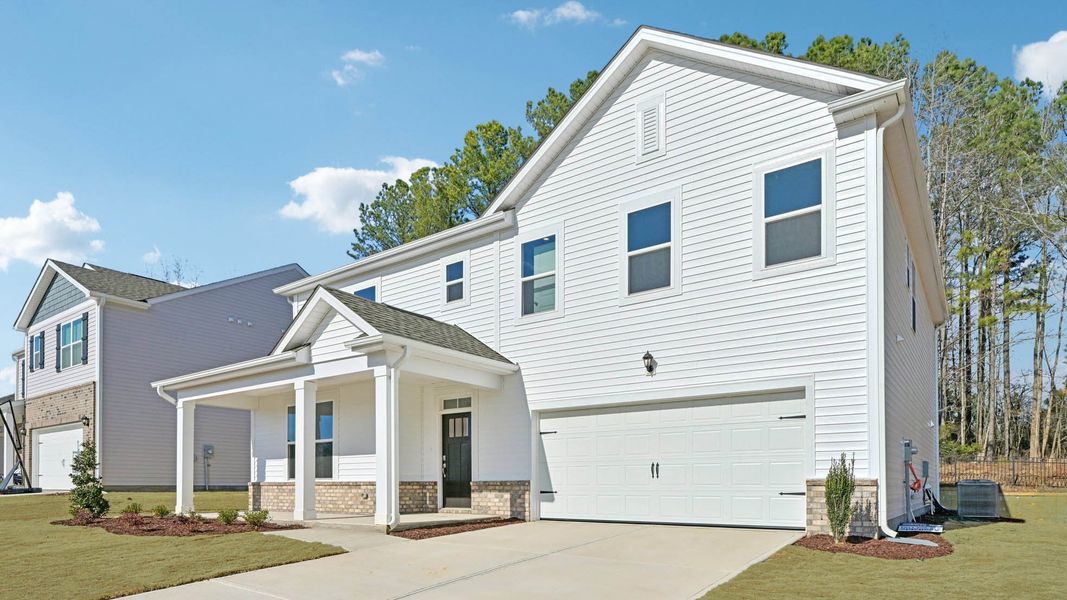Front exterior of a new home in Eagle Creek, Fuquay Varina, NC, highlighting curb appeal (Image 2). Front exterior of a new home in Eagle Creek, Fuquay Varina, NC, highlighting curb appeal (Image 2).