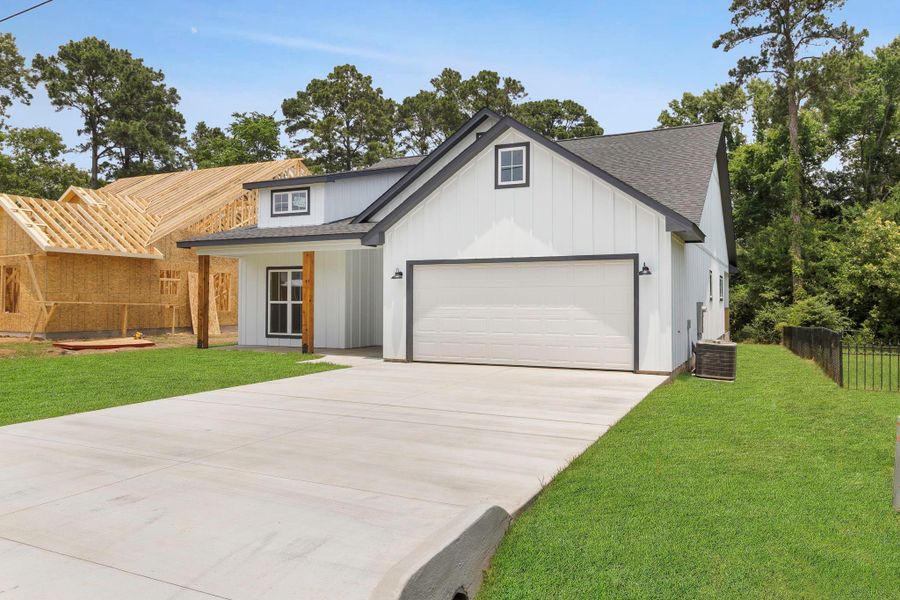 Front exterior of a new home in , Onalaska, TX, highlighting curb appeal (Image 1).