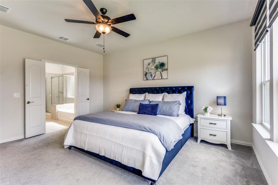 Large primary bedroom with double doors to the ensuite bathroom Large primary bedroom with double doors to the ensuite bathroom