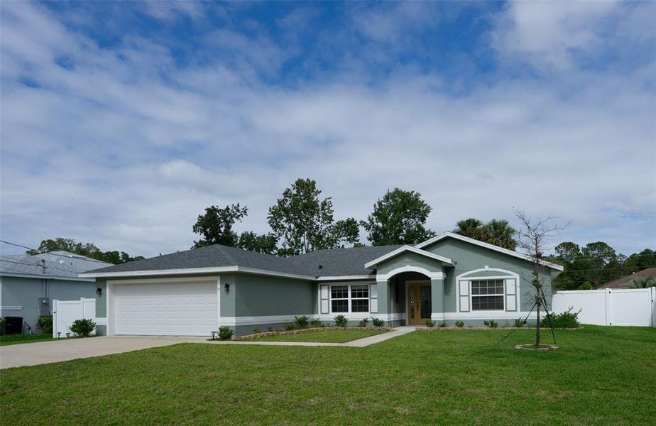 Front exterior of a new home in , Palm Coast, FL, highlighting curb appeal (Image 21).
