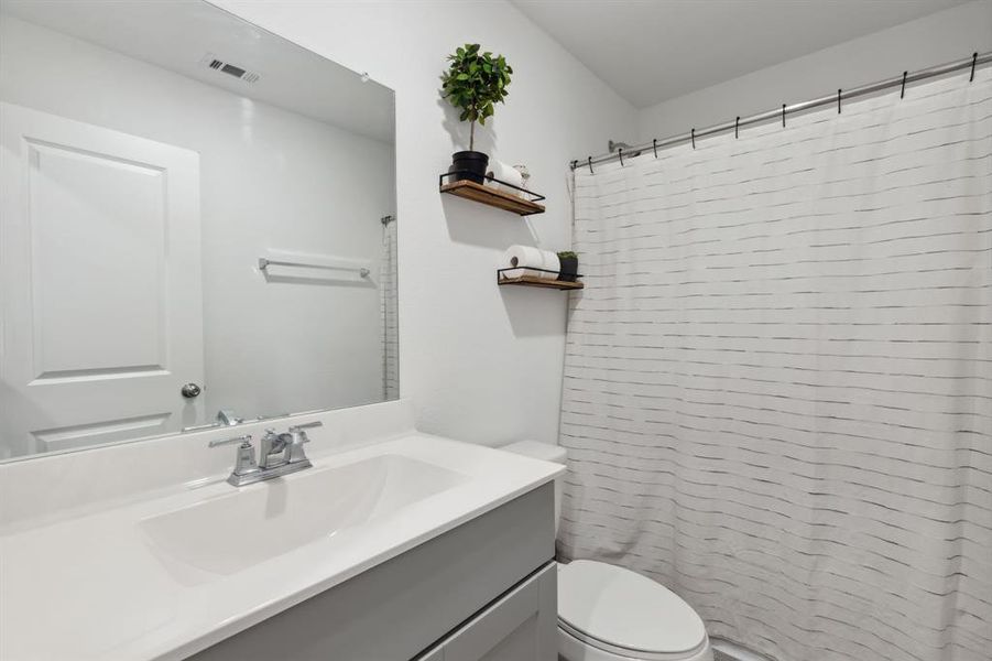 Secondary bathroom located right by the two secondary bedrooms