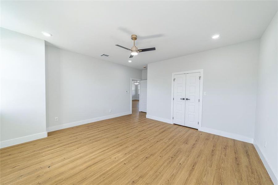 Unfurnished bedroom with light wood-style floors, recessed lighting, a ceiling fan, and a closet Unfurnished bedroom with light wood-style floors, recessed lighting, a ceiling fan, and a closet