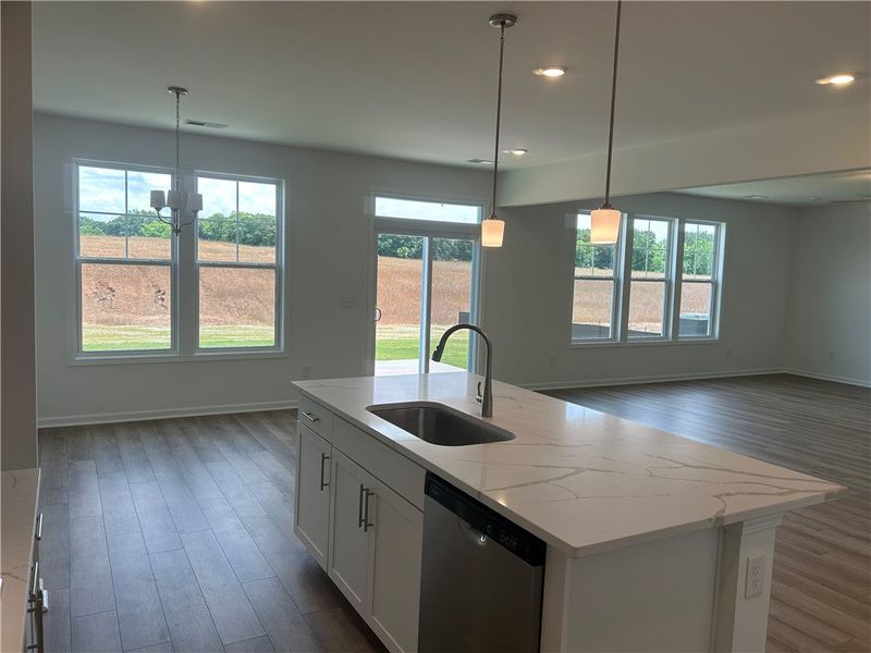 An open-concept living space with a pristine kitch