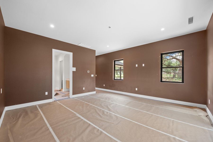 Spacious interior room with brown walls and white trim