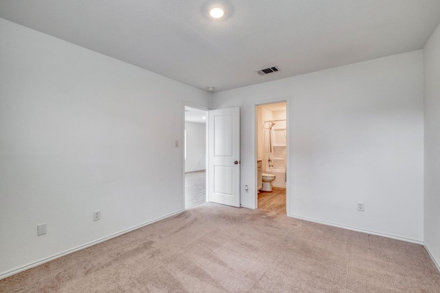 Carpeted room with white walls, baseboards, and a ceiling light fixture