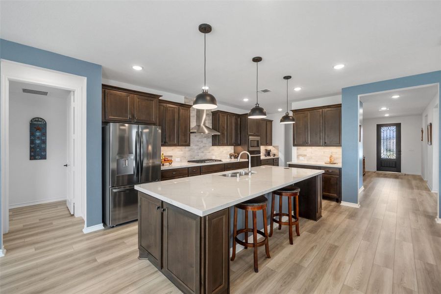 The cabinets are alder walnut stain and the appliances are stainless steel.