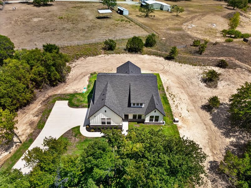 Front exterior of a new home in Monarch Manor, Poolville, TX, highlighting curb appeal (Image 32).