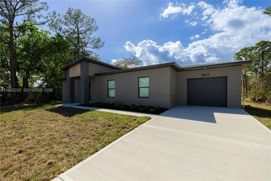 Front exterior of a new home in , Palm Bay, FL, highlighting curb appeal (Image 29).