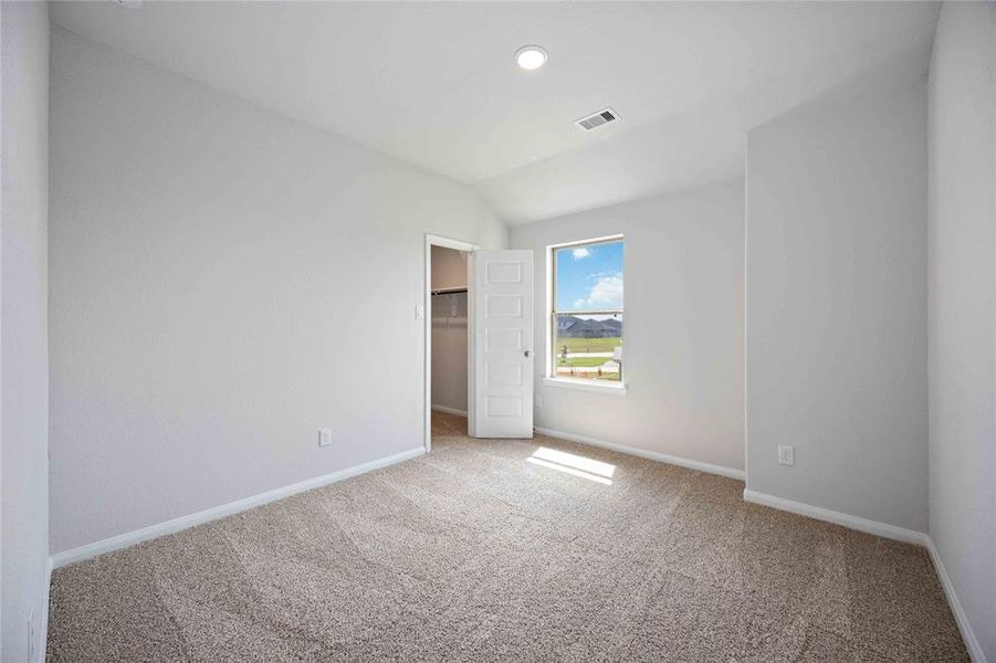 Welcome to the spacious secondary bedroom that features a comfy plush carpet and abundant natural light!