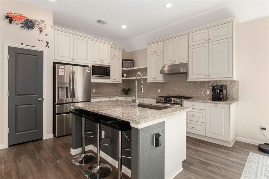 Kitchen with beautiful granite countertops, stainless steele appliances, and custom cabinets.