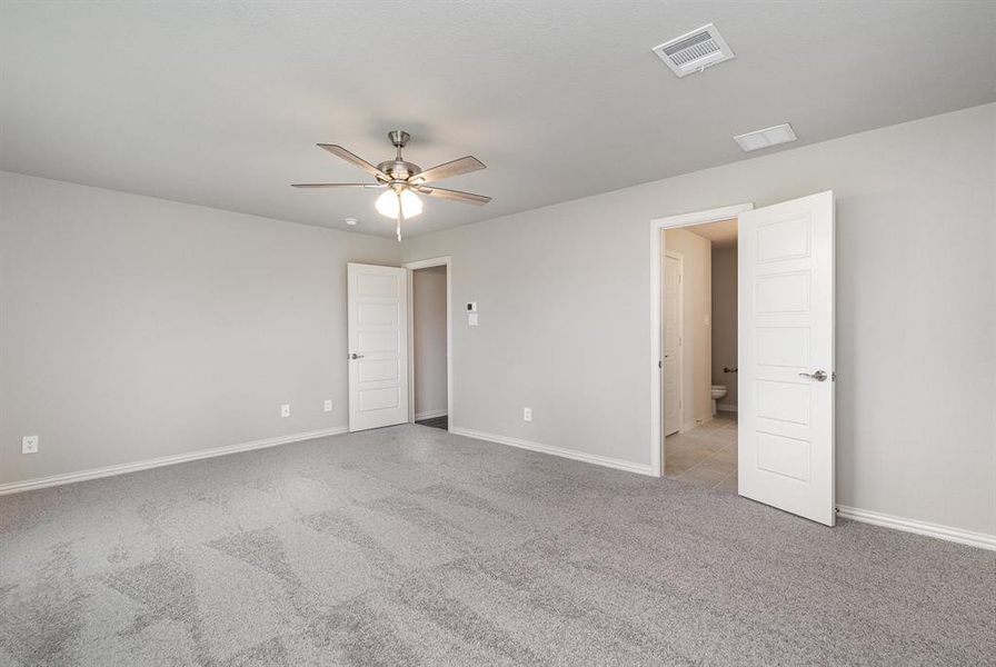 Unfurnished room with ceiling fan and light colored carpet