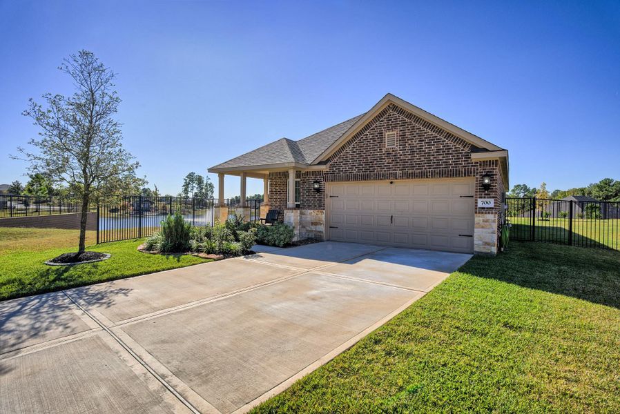 Front exterior of a new home in Wedgewood Forest, Conroe, TX, highlighting curb appeal (Image 2). Front exterior of a new home in Wedgewood Forest, Conroe, TX, highlighting curb appeal (Image 2).