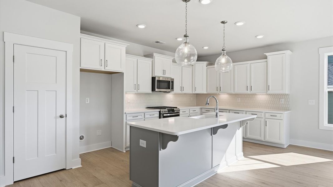 Tasteful kitchen with a streamlined island and modern finishes in a first-class DRB Homes design